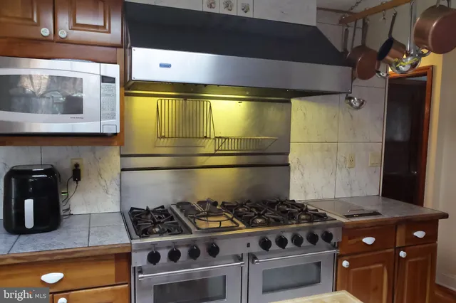a kitchen with a sink a counter top space and cabinets