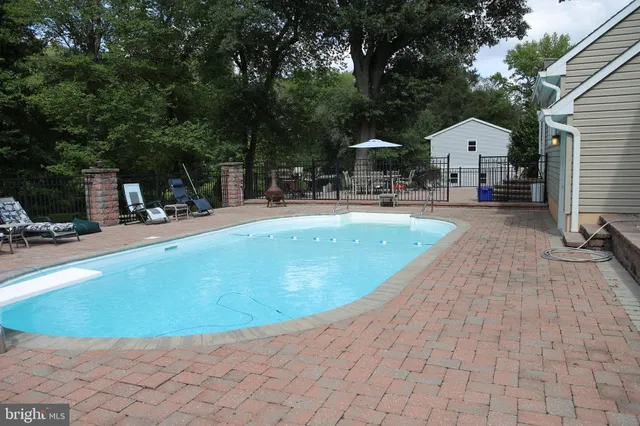 a swimming pool with outdoor seating and yard