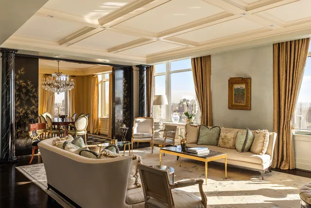 a living room with furniture and large windows