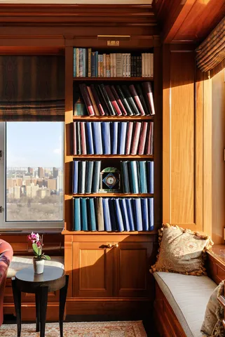 a living room with furniture and a book shelf