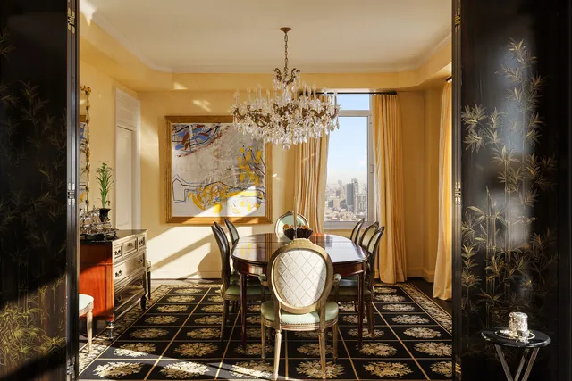 a view of a dining room with furniture and a chandelier