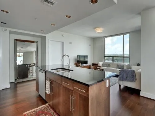 a view of living room with furniture and wooden floor