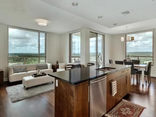 a living room with furniture and large windows