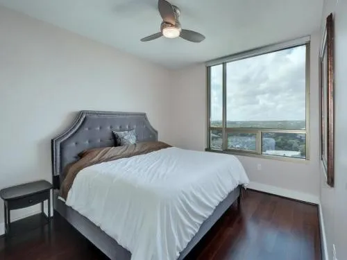 a bedroom with a large bed and a large window