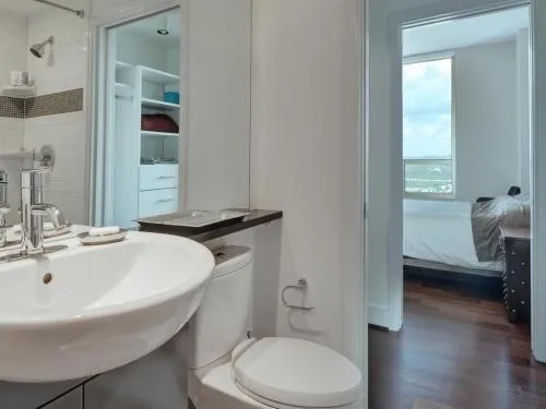 a bathroom with a sink a toilet and shower