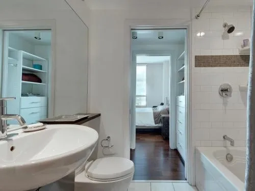 a bathroom with a sink a toilet and shower