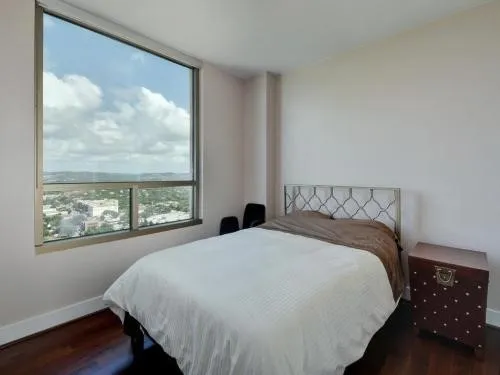 a bedroom with a large bed and a window