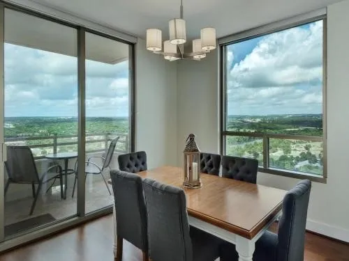 a view of a dining room with furniture large windows and wooden floor