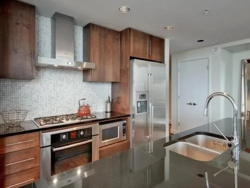a kitchen with stainless steel appliances granite countertop a sink stove and refrigerator