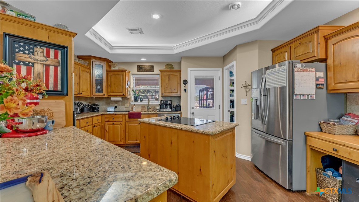 306 Alexander Avenue Burnet, TX 78611 - Photo 11 of 38 a kitchen with stainless steel appliances granite countertop a refrigerator and a stove