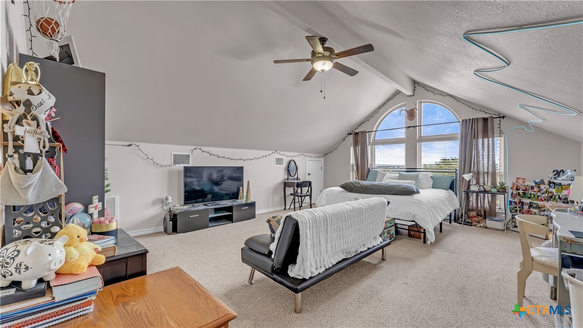 306 Alexander Avenue Burnet, TX 78611 - Photo 15 of 38 a bed room with furniture and a fireplace