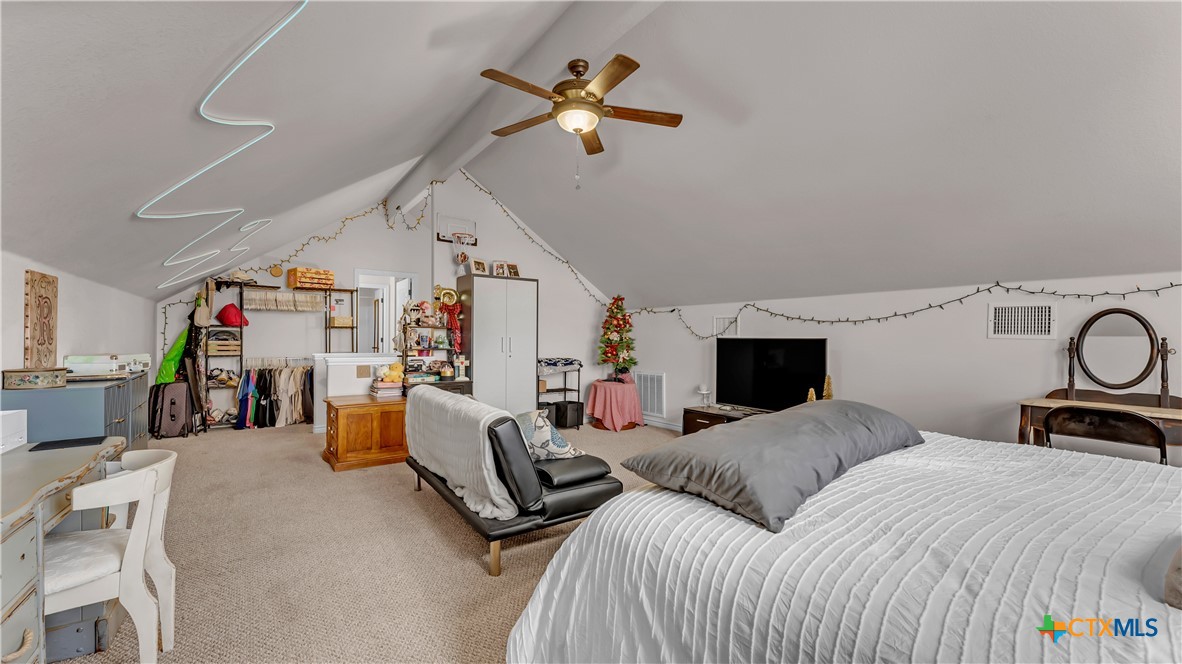 306 Alexander Avenue Burnet, TX 78611 - Photo 16 of 38 a bedroom with furniture and a ceiling fan