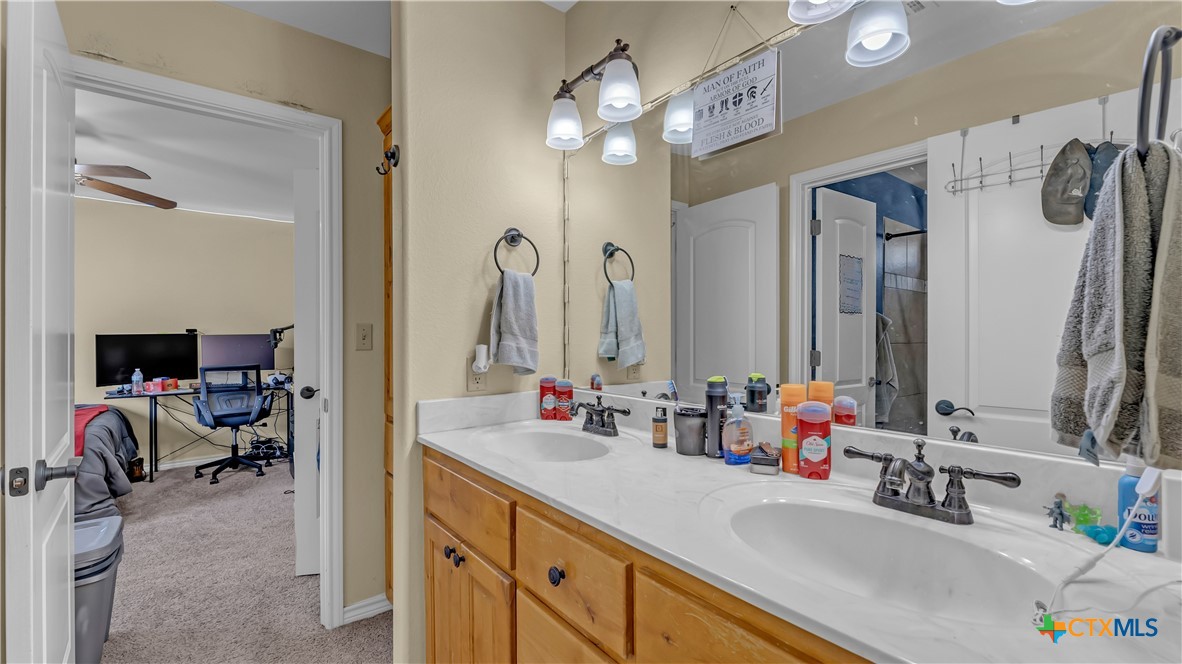 306 Alexander Avenue Burnet, TX 78611 - Photo 20 of 38 a bathroom with a sink double vanity and a mirror