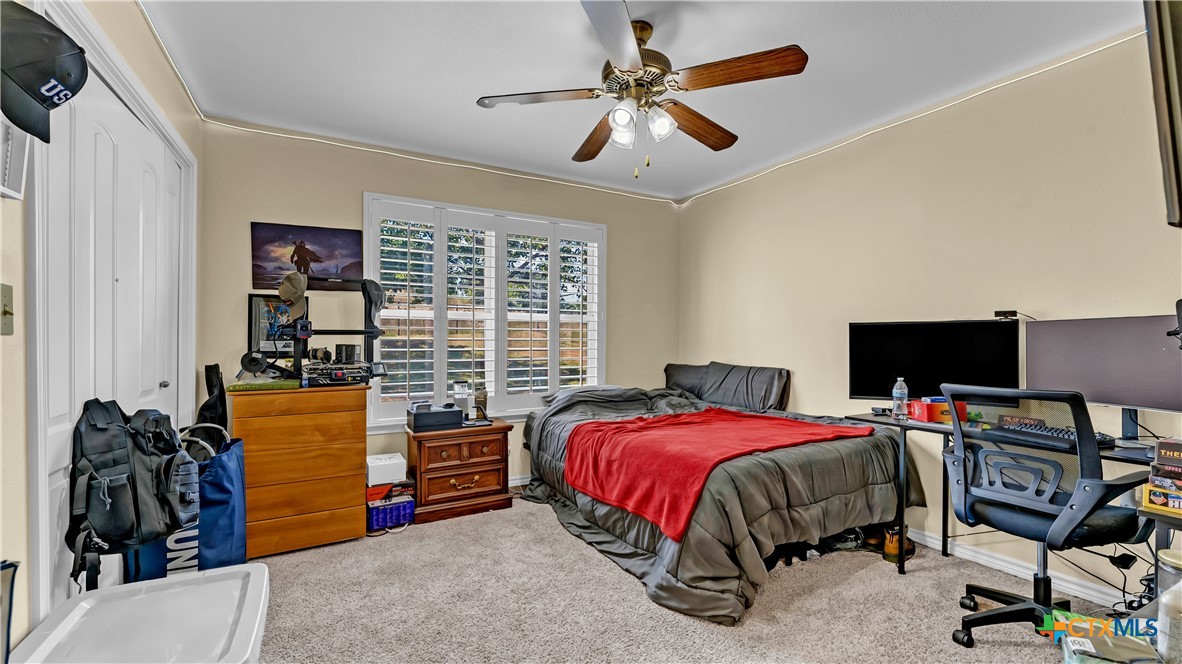 306 Alexander Avenue Burnet, TX 78611 - Photo 21 of 38 a bedroom with a bed and a desk