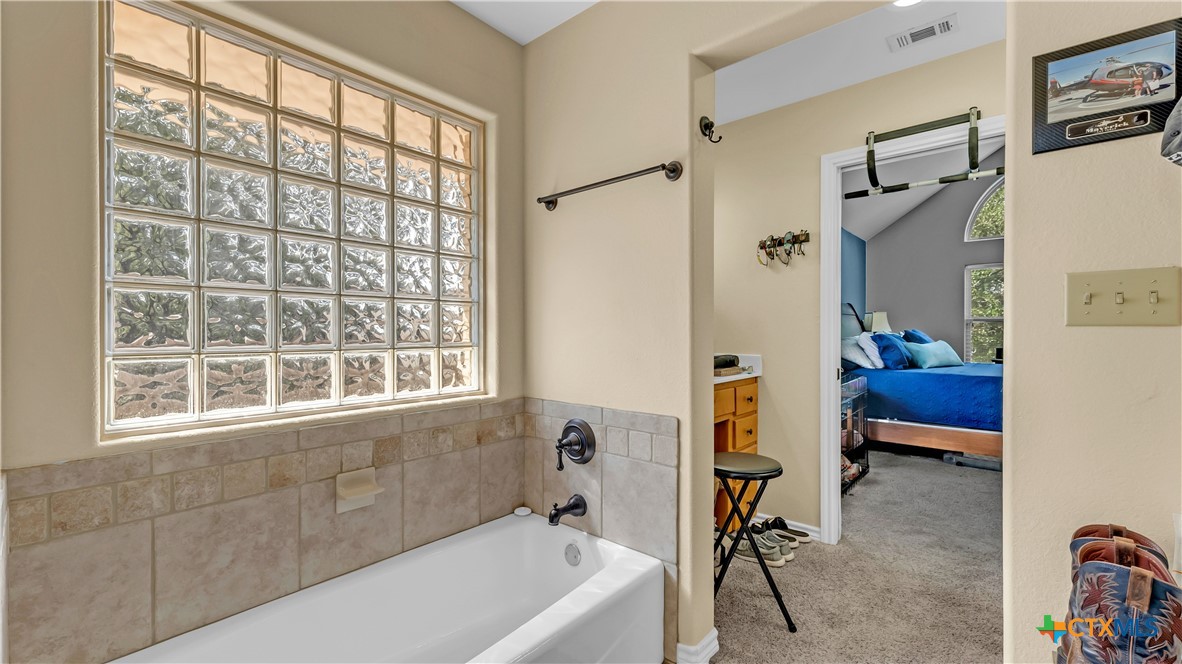 306 Alexander Avenue Burnet, TX 78611 - Photo 26 of 38 a bathroom with a bathtub and a shower