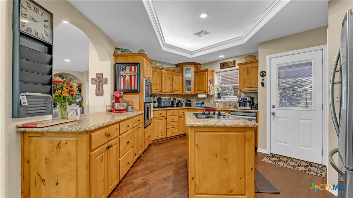 306 Alexander Avenue Burnet, TX 78611 - Photo 10 of 38 a kitchen with stainless steel appliances granite countertop a stove and a sink