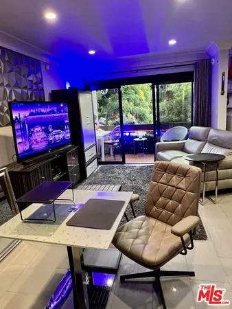 a living room with table and chairs