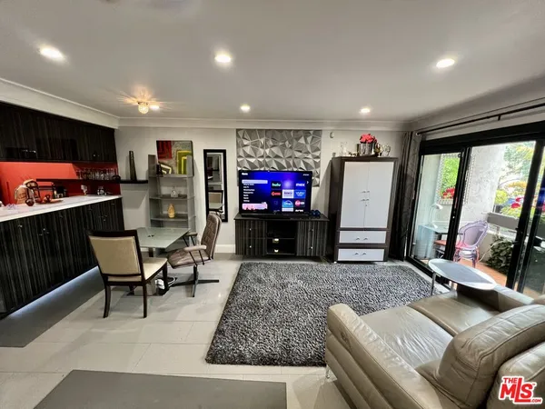 a sitting area with furniture and a floor to ceiling window