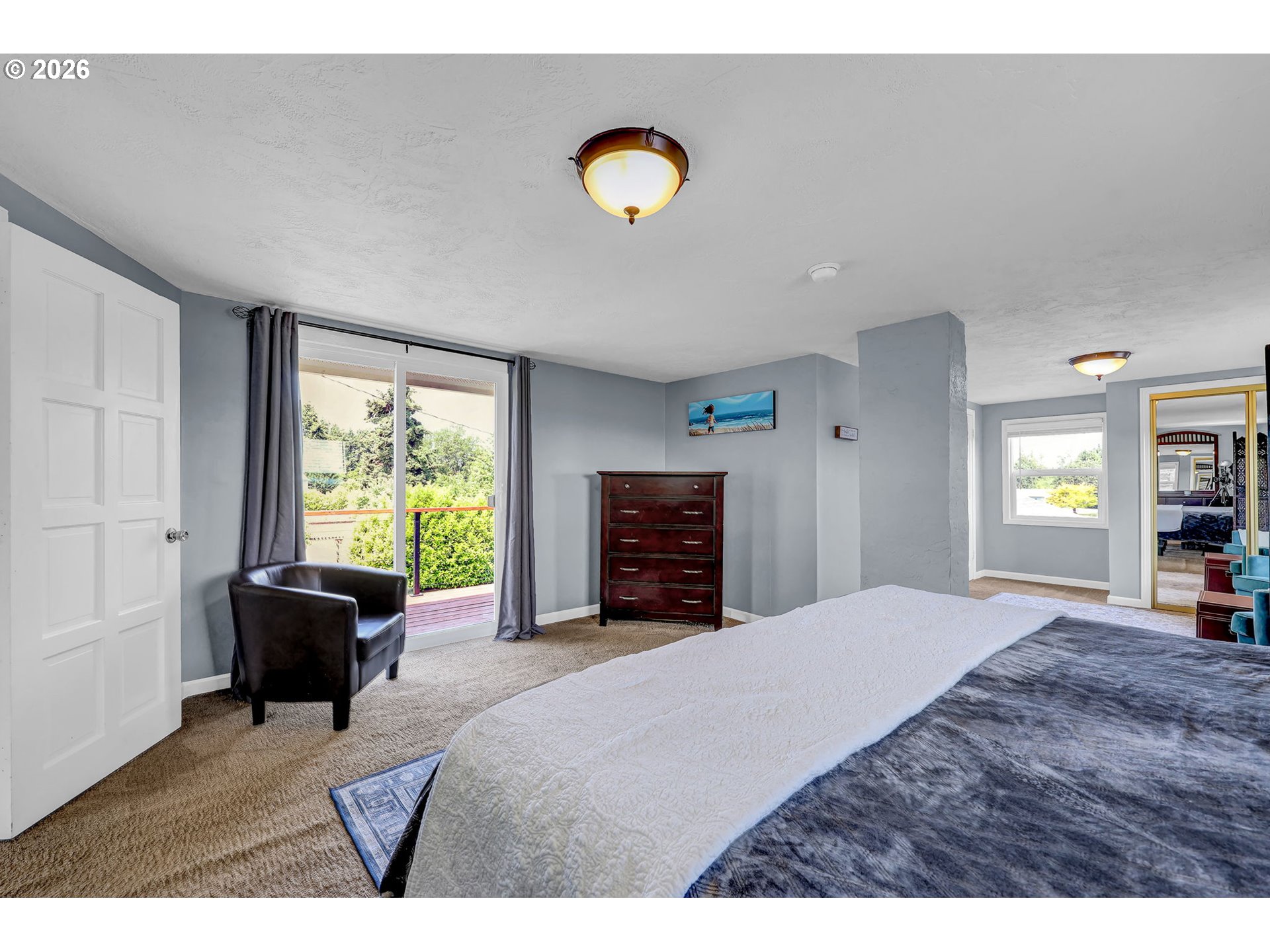 90440 Goodman Road Junction City, OR 97448 - Photo 20 of 48 a bedroom with a bed and a chandelier