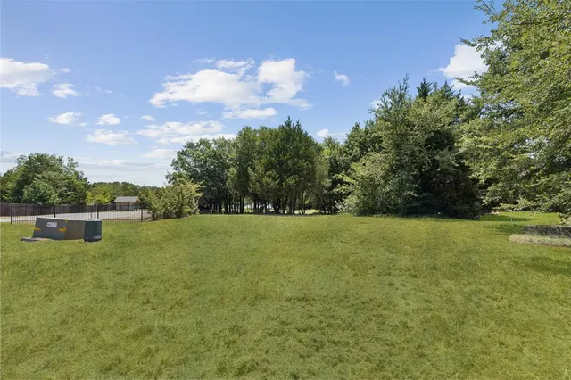 a view of outdoor space with green field and trees