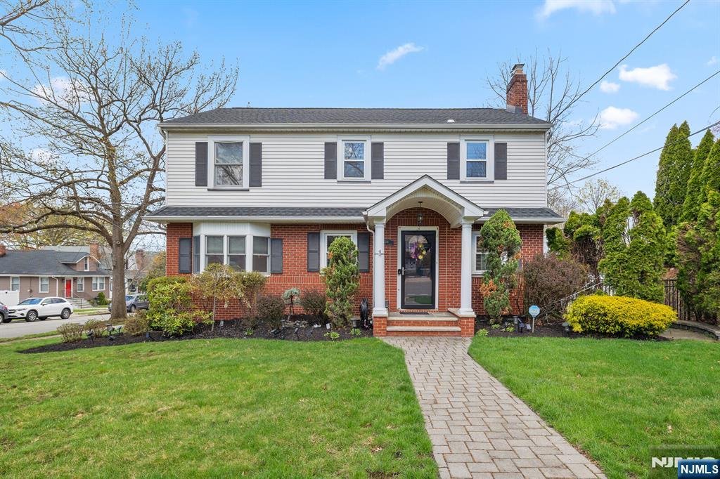 a front view of a house with garden and porch