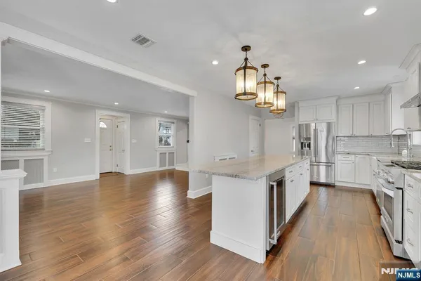 a kitchen with cabinets and stainless steel appliances