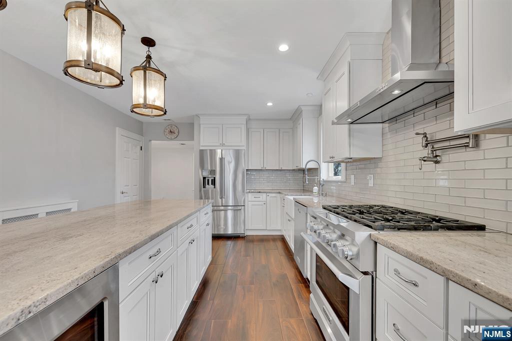 346 Carmita Avenue Rutherford, NJ 07070 - Photo 13 of 47 a kitchen with cabinets and stainless steel appliances