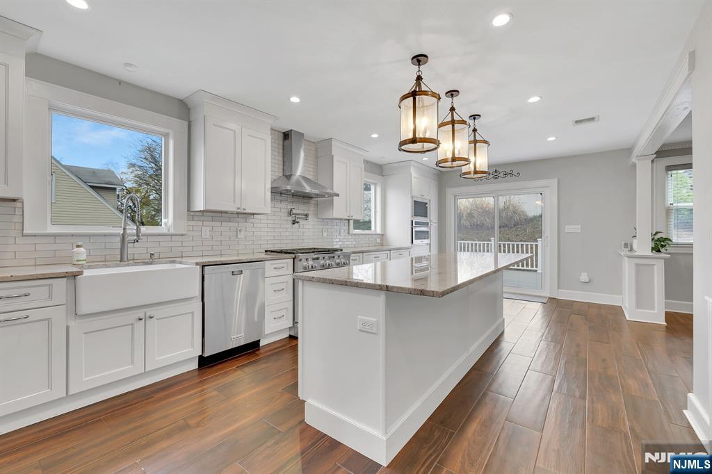 346 Carmita Avenue Rutherford, NJ 07070 - Photo 14 of 47 a large kitchen with cabinets wooden floor and stainless steel appliances