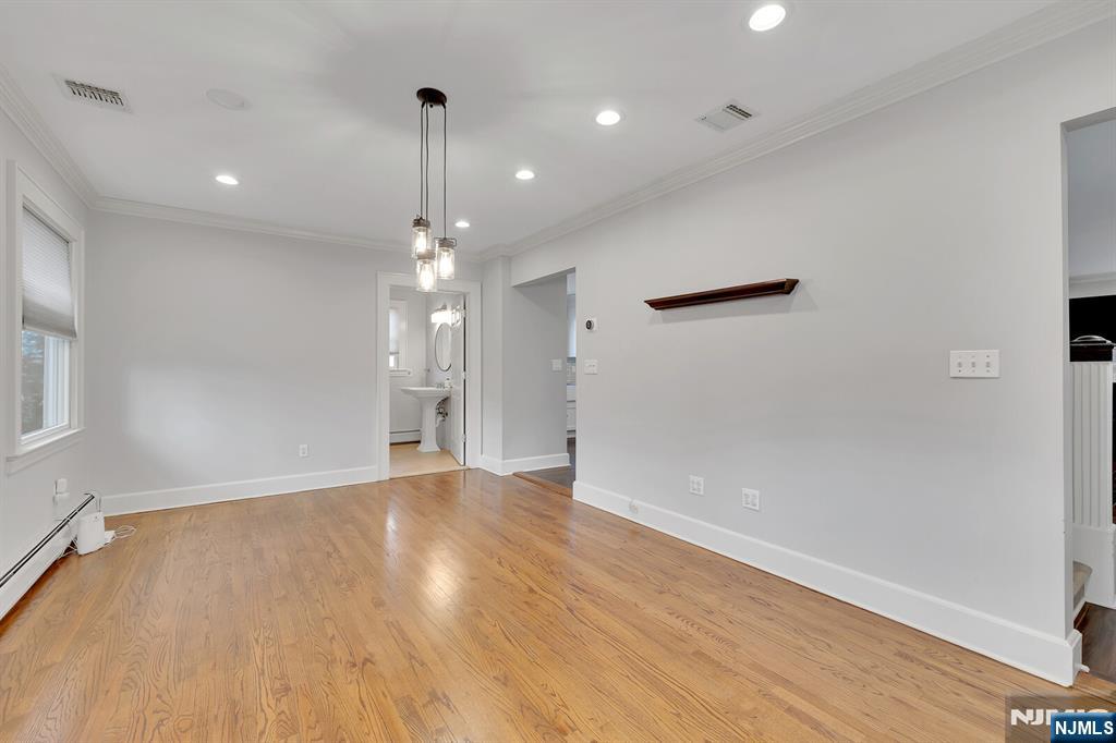 346 Carmita Avenue Rutherford, NJ 07070 - Photo 16 of 47 a view of an empty room with wooden floor and a window