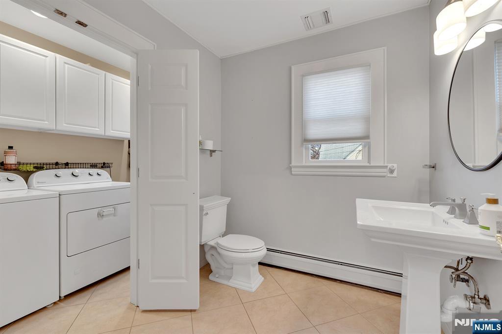 346 Carmita Avenue Rutherford, NJ 07070 - Photo 17 of 47 a bathroom with a sink toilet and a mirror