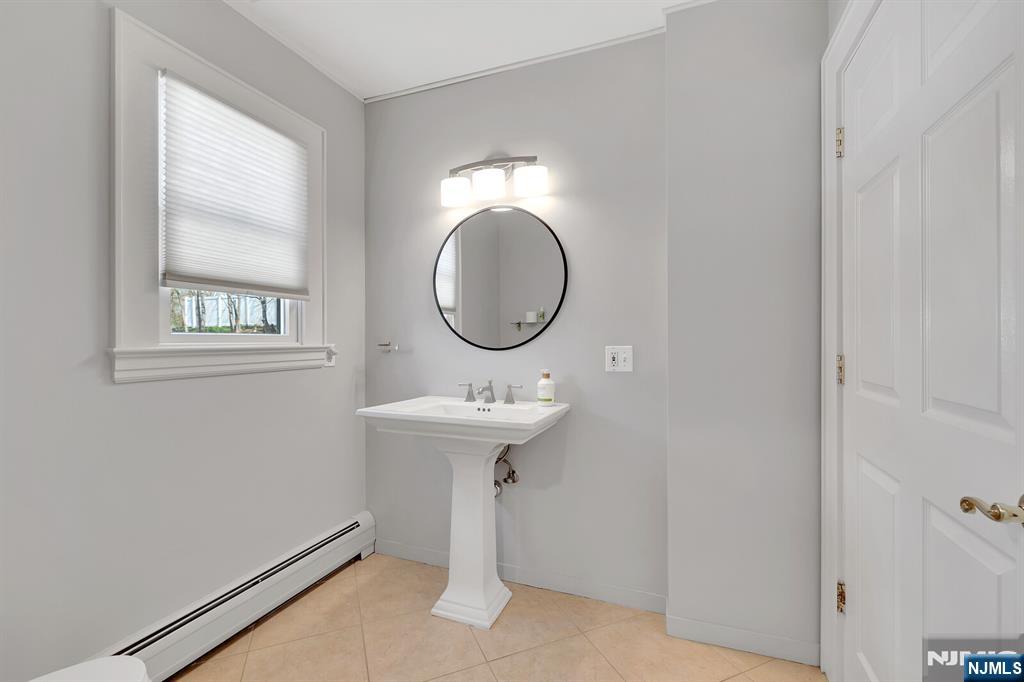 346 Carmita Avenue Rutherford, NJ 07070 - Photo 18 of 47 a bathroom with a sink and a mirror
