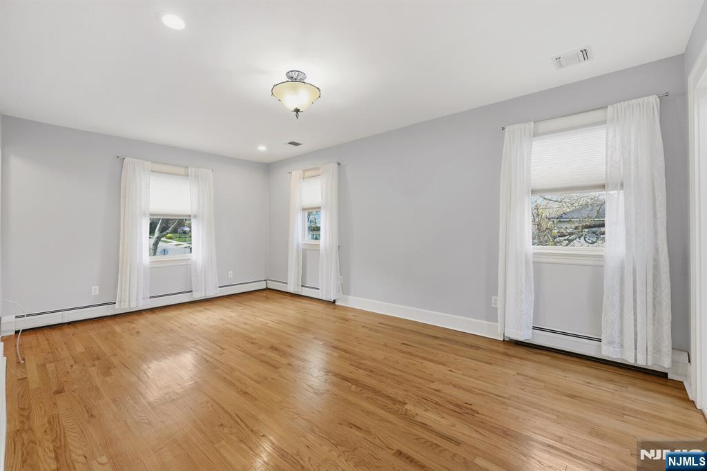 346 Carmita Avenue Rutherford, NJ 07070 - Photo 20 of 47 an empty room with wooden floor and windows