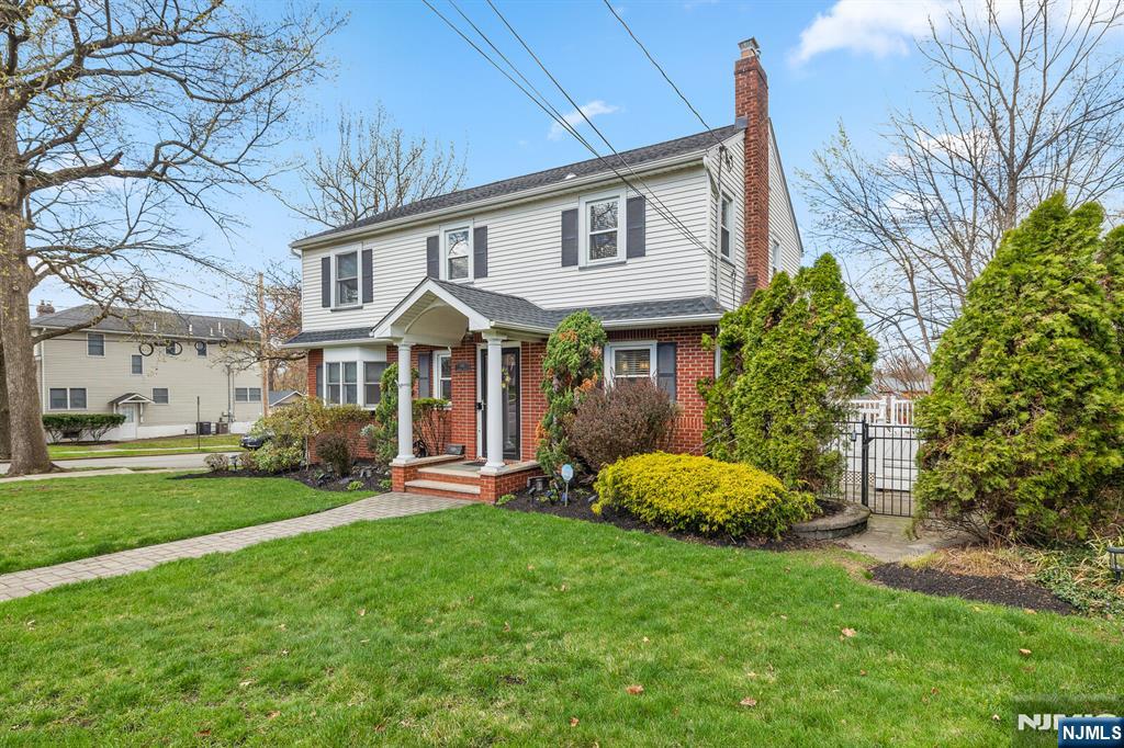 346 Carmita Avenue Rutherford, NJ 07070 - Photo 2 of 47 a front view of a house with a garden and porch