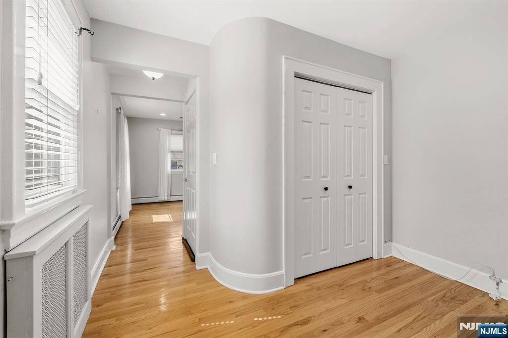 346 Carmita Avenue Rutherford, NJ 07070 - Photo 22 of 47 a view of a hallway with wooden floor and staircase