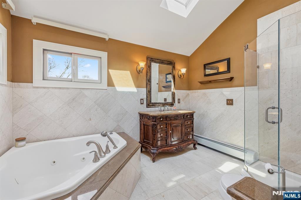 346 Carmita Avenue Rutherford, NJ 07070 - Photo 24 of 47 a bathroom with a tub a sink and mirror