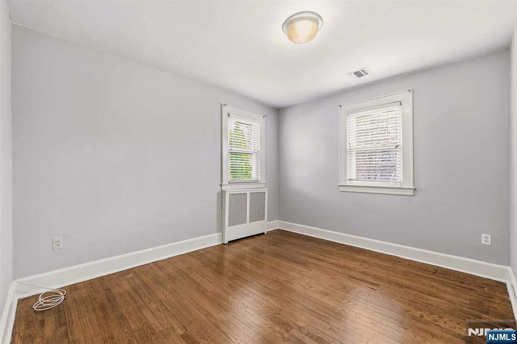 346 Carmita Avenue Rutherford, NJ 07070 - Photo 27 of 47 an empty room with wooden floor and windows