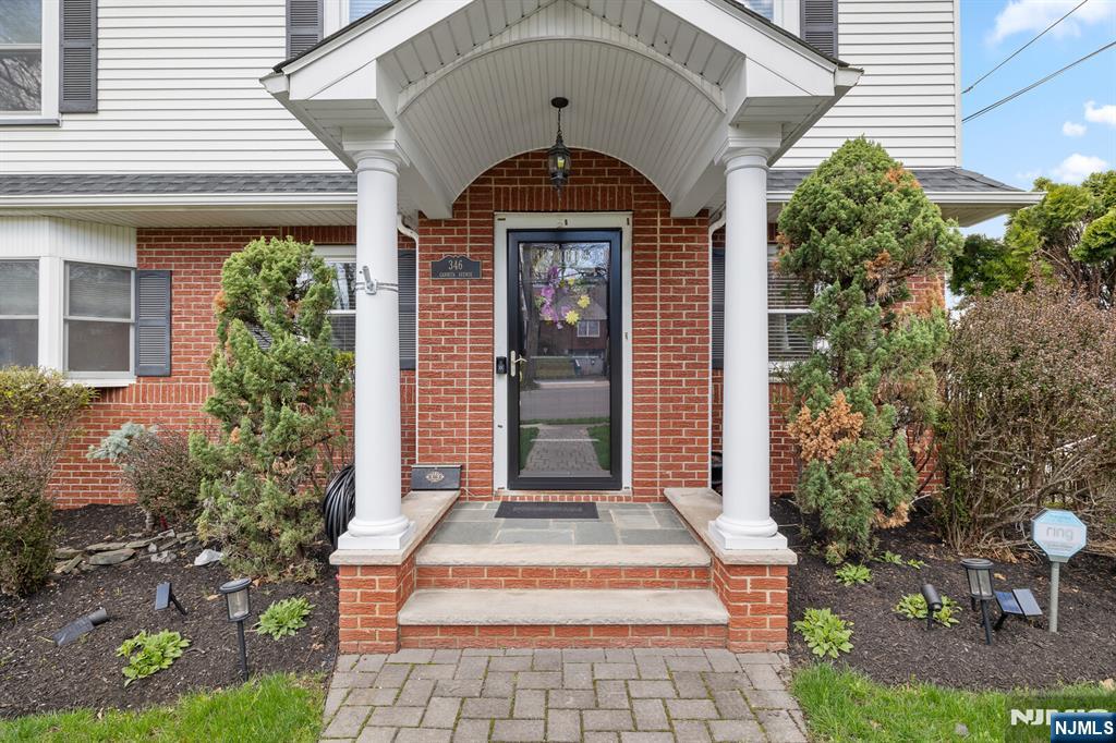 346 Carmita Avenue Rutherford, NJ 07070 - Photo 3 of 47 a front view of a house with a porch