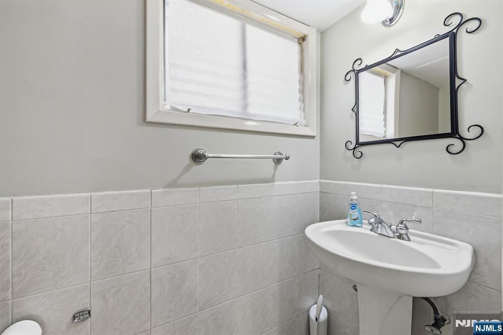 346 Carmita Avenue Rutherford, NJ 07070 - Photo 33 of 47 a bathroom with a sink a toilet and a mirror