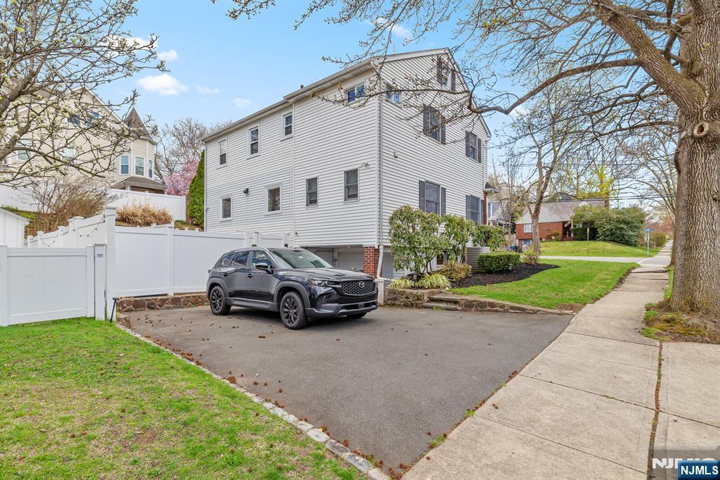 346 Carmita Avenue Rutherford, NJ 07070 - Photo 36 of 47 a car parked in front of white house