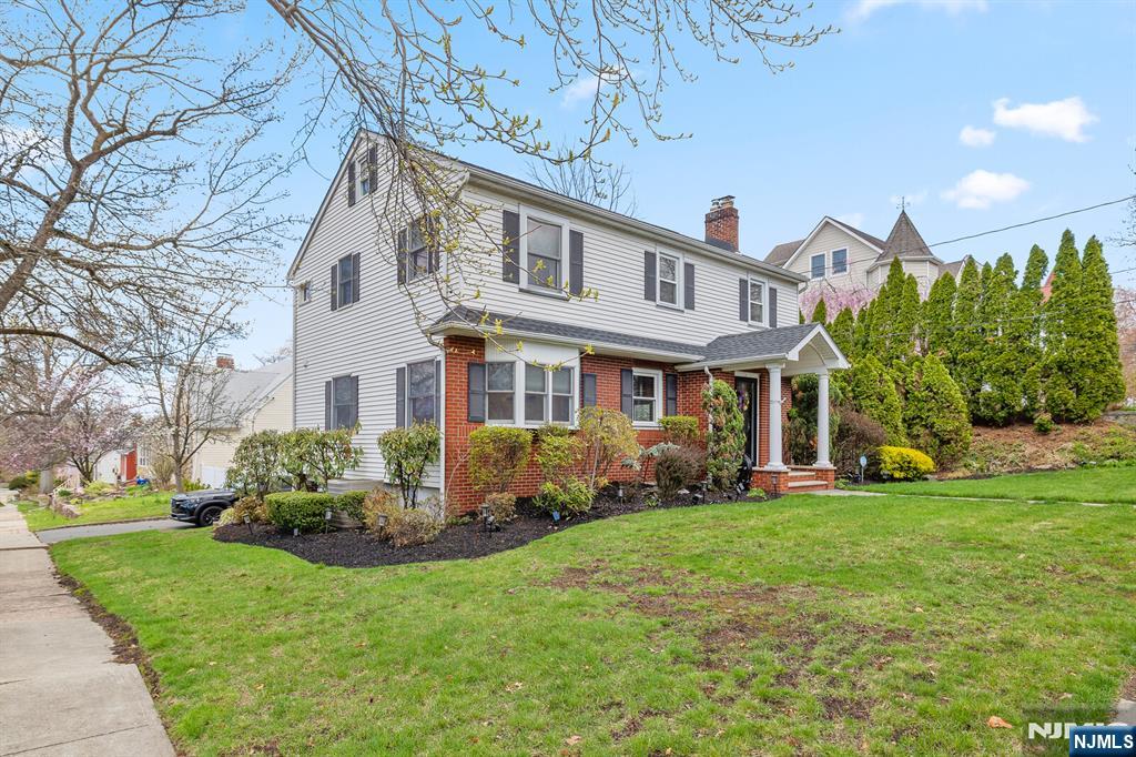 346 Carmita Avenue Rutherford, NJ 07070 - Photo 42 of 47 a front view of a house with a garden and plants