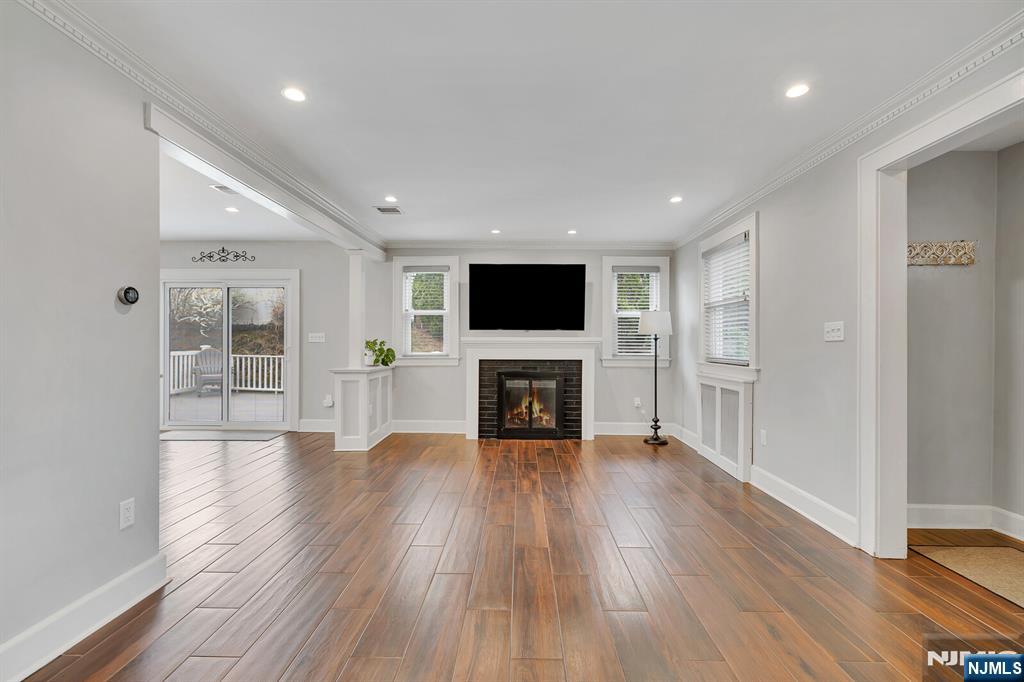 346 Carmita Avenue Rutherford, NJ 07070 - Photo 6 of 47 a view of a big room with wooden floor and a fireplace