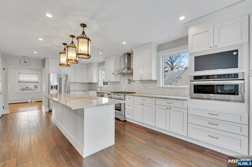 346 Carmita Avenue Rutherford, NJ 07070 - Photo 10 of 47 a kitchen with stainless steel appliances a sink stove and cabinets