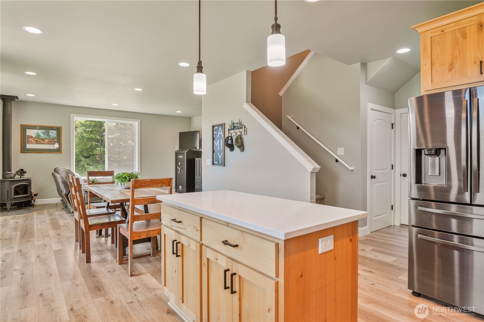 327 Parpala Road Naselle, WA 98638 - Photo 24 of 39 a open kitchen with stainless steel appliances granite countertop a refrigerator a stove a dining table and chairs with wooden floor