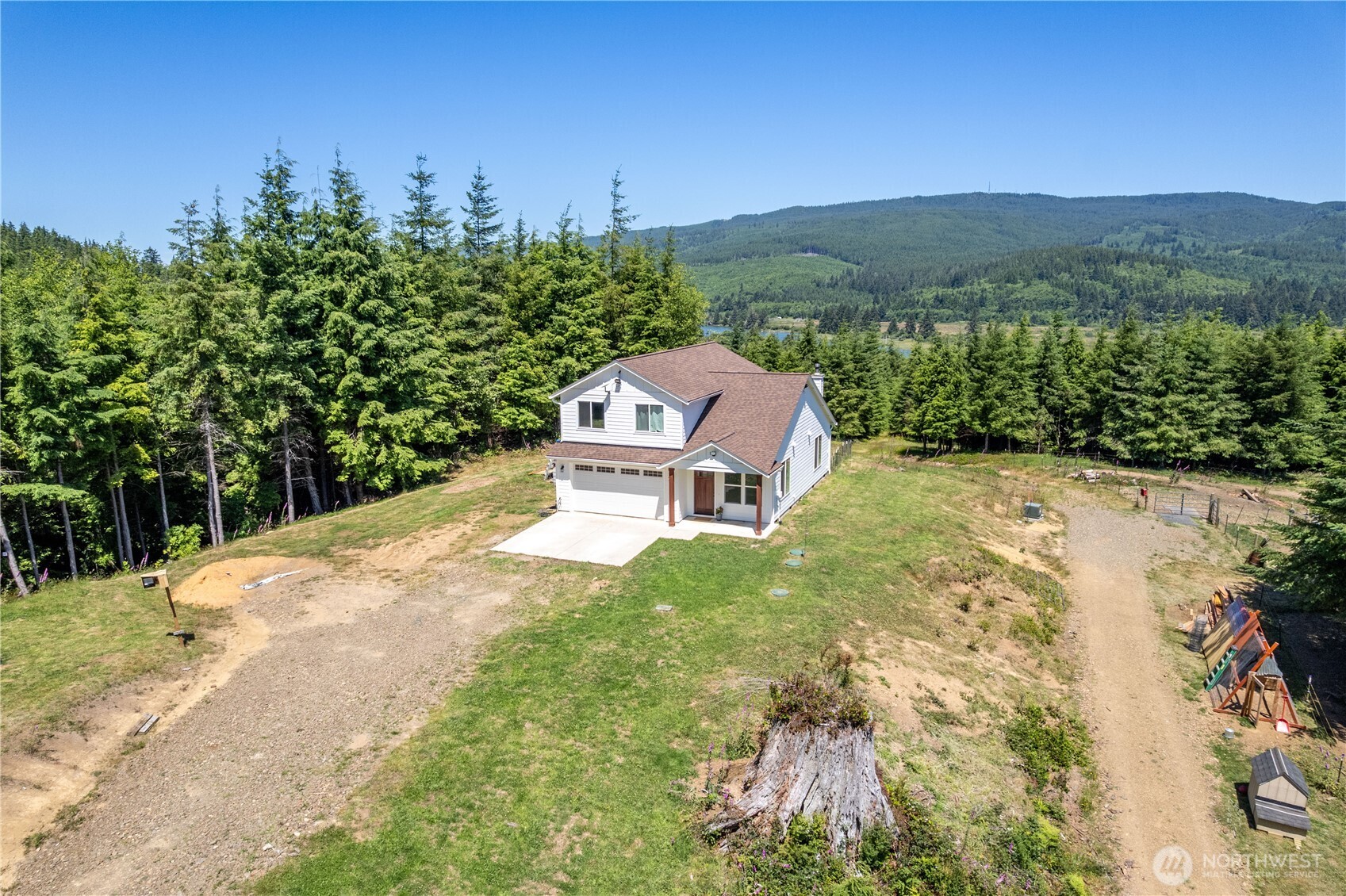 327 Parpala Road Naselle, WA 98638 - Photo 36 of 39 a view of a garden with a building in the background