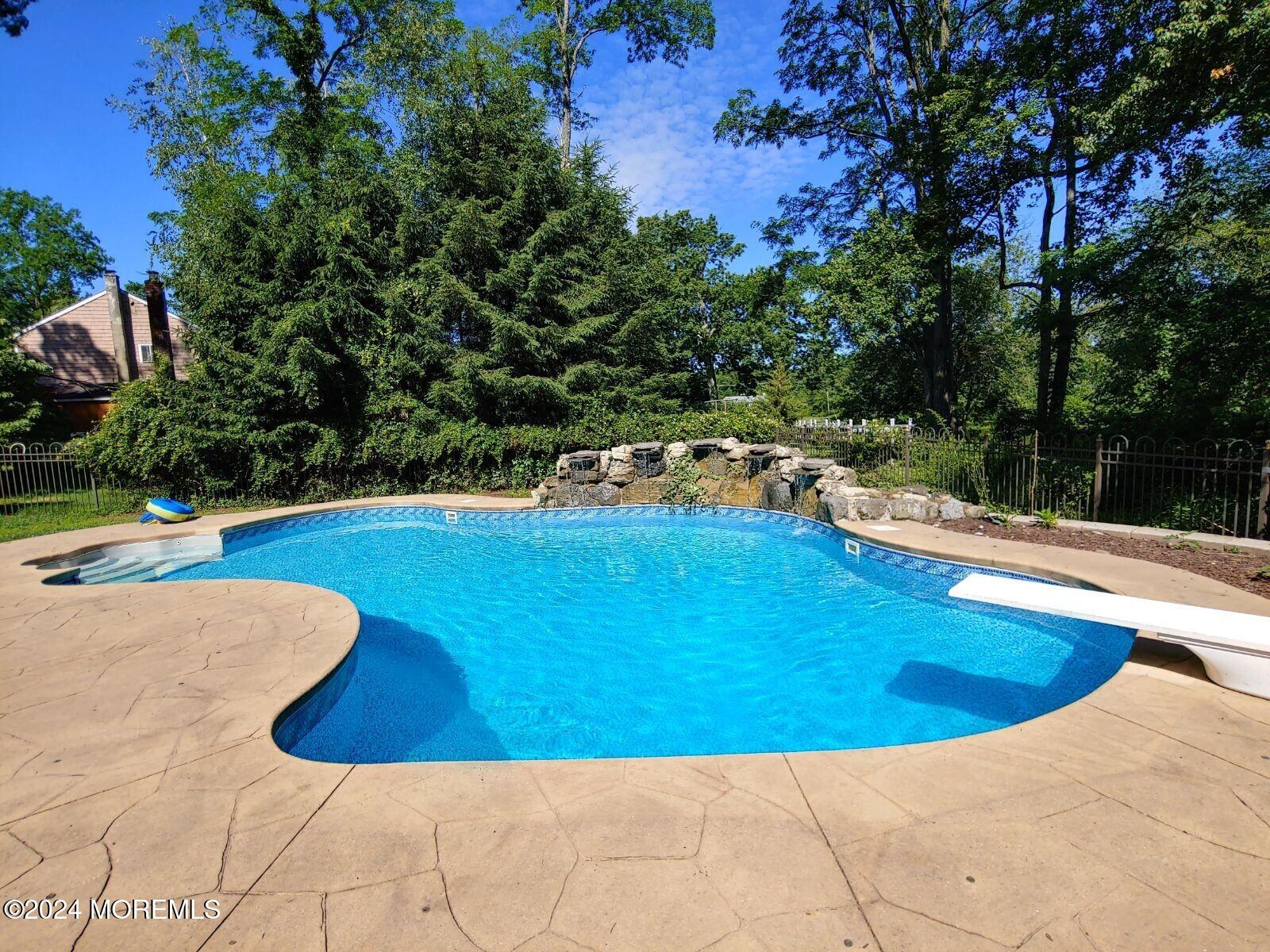 1 Cooper Drive Howell, NJ 07731 - Photo 14 of 40 a view of a swimming pool with an outdoor seating