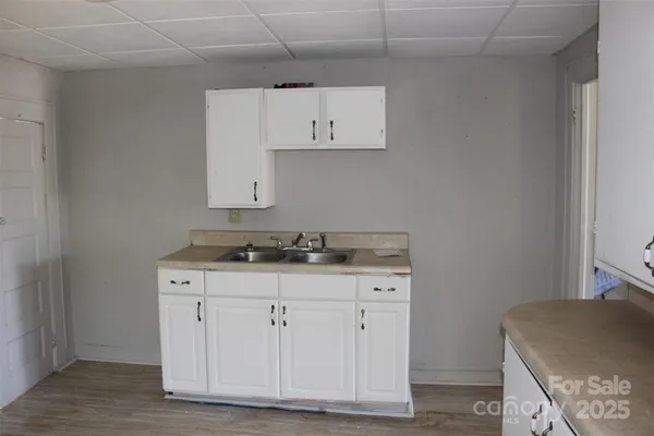 a kitchen with a sink cabinets and stove top oven