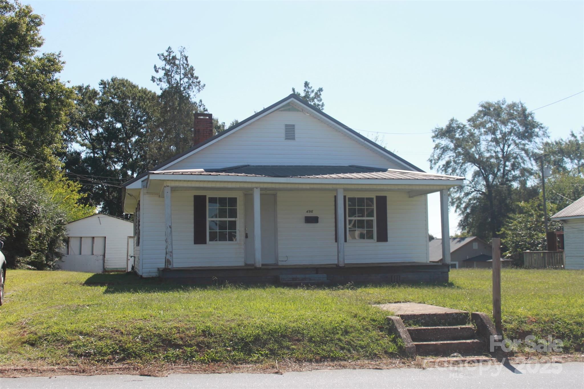 496 Spindale Street Spindale, NC 28160 - Photo 3 of 25 a front view of a house with garden