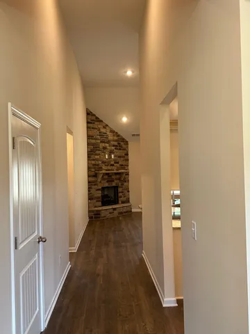 a view of a hallway with wooden shelves