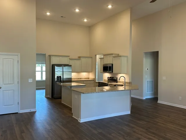 a kitchen with stainless steel appliances granite countertop a stove and a refrigerator