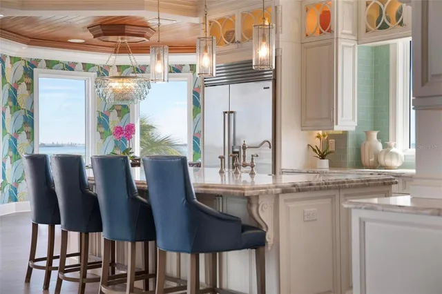 a living room with furniture a flat screen tv and kitchen view